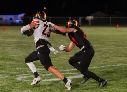 Monticello teammates Arturo Gutierrez (23) and Miles Coleman (24) battle at the Orange/Black scrimmage. Anna Fredericks photo