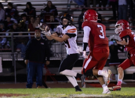 Monticello's Miles Coleman grabs a pass in stride from Cache Young for a touchdown at the end of the half. Anna Fredericks photo