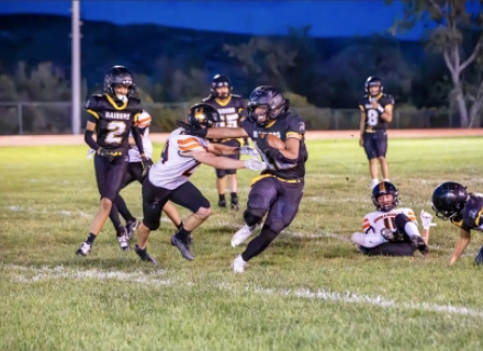 Whitehorse running back Hunter Tsinigine stiffarms Monticello’s Miles Coleman to gain some of his nearly 200 yards against the Buckaroos on September 21 in Montezuma Creek. Also in on the play are Dillion Leo (#2), Eliyeontay Silas (#55), Tyrell Black (#8), and Canyon Christensen (#11).  Katelyn Yellowman photo